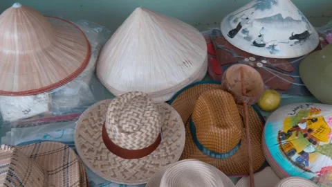 Vietnamese bamboo non la conical hats with colorful drawings and other hats Stock Footage 333365685