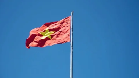 Vietnamese bright red flag waving on the blue colorful background Stock Footage 127466894