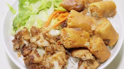 Vietnamese Bun Cha Gio Noodle Bowl with Sliced Crispy Spring Rolls Stock Footage 346411311