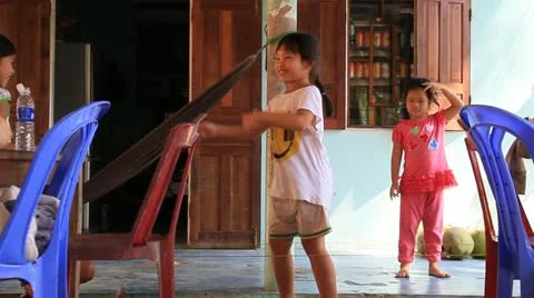 Vietnamese children playing jump rope at their home in Hoi An. Stock Footage 18174662