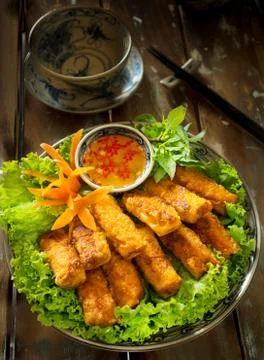 Vietnamese crispy spring rolls or Nem nuong with fish sauce and lettuce Stock Photos