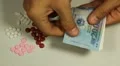 Vietnamese Dong VND, Counting Drugs and Money, Health Care, Colorful Pills HD Footage