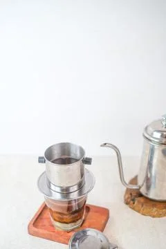 Vietnamese Drip Coffee Brewing Process With Stainless Steel Filter On Glass.. Stock Photos