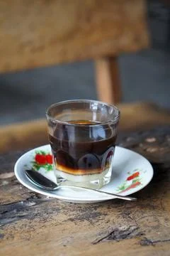 Vietnamese drip coffee made with bold robusta on a wooden table Stock Photos
