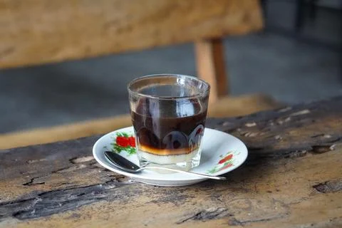 Vietnamese drip coffee made with bold robusta on a wooden table Stock Photos