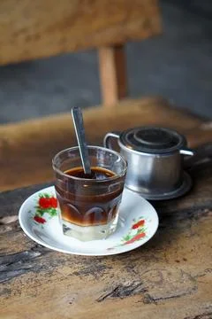 Vietnamese drip coffee made with bold robusta on a wooden table Stock Photos