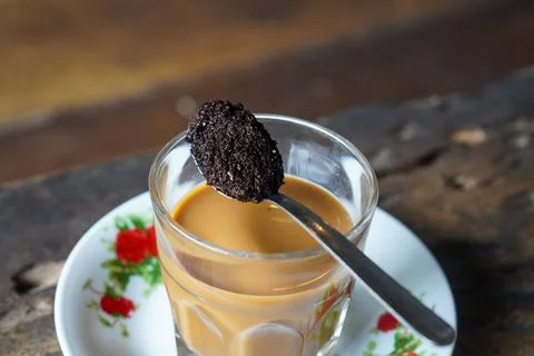 Vietnamese drip coffee made with bold robusta on a wooden table Stock Photos