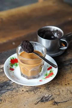 Vietnamese drip coffee made with bold robusta on a wooden table Stock Photos