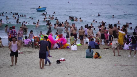 Vietnamese families relax on the beach a... | Stock Video | Pond5