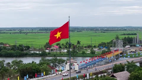 Vietnamese flag and bridge at former DMZ wide aerial 4K Stock Footage 339865344