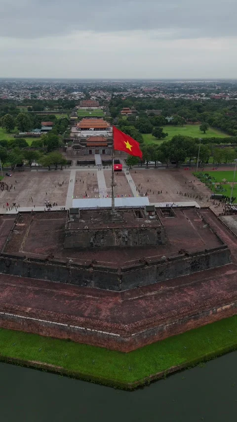 Vietnamese Flag Flying Atop the Flagpole in Hue, Vietnam Stock Footage 335836504