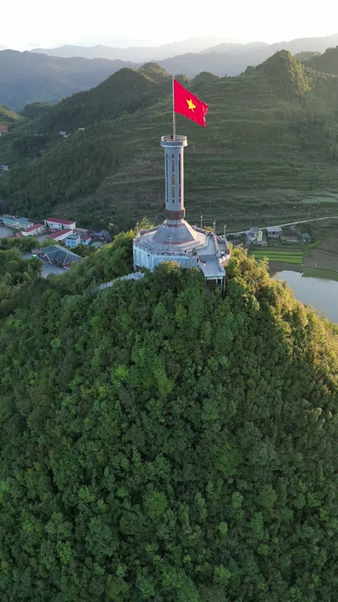 Vietnamese Flag Waving on Lung Cu Flag Tower in Ha Giang, Vietnam Stock Footage 334619436