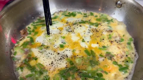 Vietnamese omelet cooking in a pan, authentic local street food Stock Footage 327844479