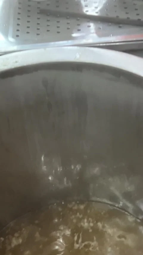 Vietnamese Phobo Soup Close-up of hands serving hot soup from large pots in a Stock Footage 307672746