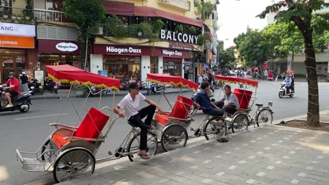 Vietnamese Rickshaw drivers wait for tourists in Hanoi, Vietnam 4K Stock Footage 245802487