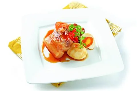 Vietnamese simmered meat with egg on white platter Stock Photos