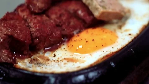 Vietnamese sizzling steak and eggs (Bò Né) Stock Footage 320410776