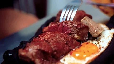 Vietnamese sizzling steak and eggs (Bò Né) Stock Footage 320410777