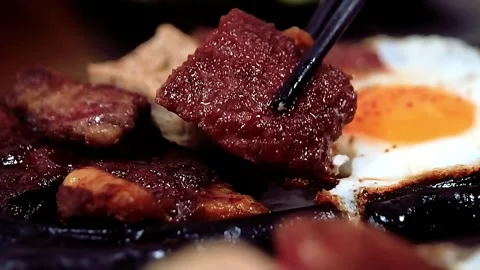 Vietnamese sizzling steak and eggs (Bò Né) Stock Footage 320410778