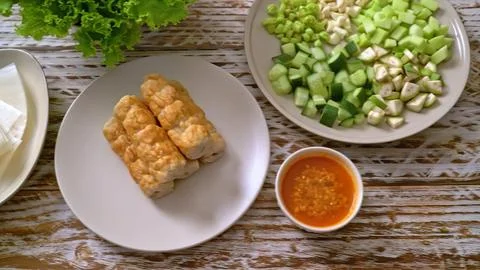 Vietnamese spring rolls with dipping sauce and vegetables Stock Photos