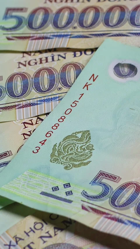 Vietnamese (VND) banknotes are falling down on rotating surface. 動画素材 336721770