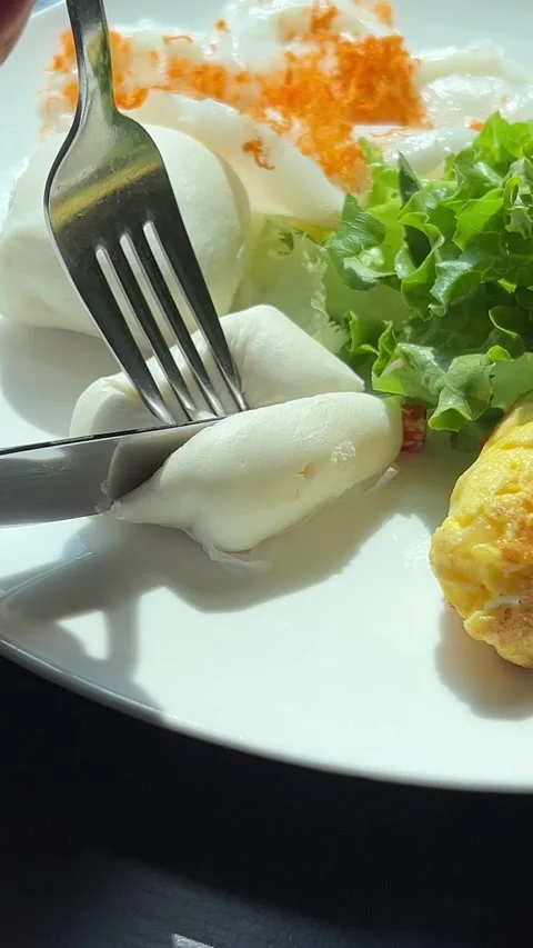 Vietnamese white buns cheese breakfast. A cut open croissant and some scrambled Stock Footage 317712619