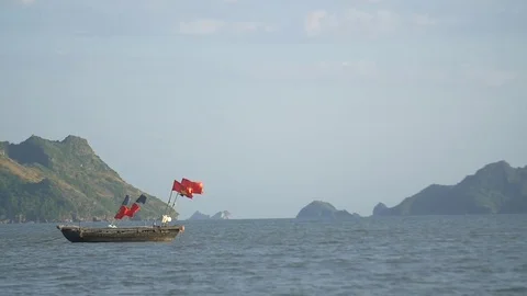 Vietnemese fishing boat on the bay with tropical islands in background Stock Footage