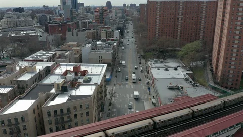 View of 125th St. descending alongside elevated subway in Harlem NYC Stock Footage 127954474