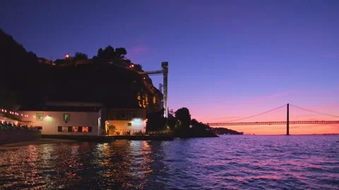 View of 25 de Abril Bridge over Tagus river on sunset. Lisbon, Portugal Stock Footage 243191747