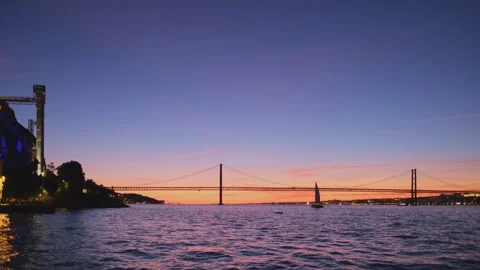 View of 25 de Abril Bridge over Tagus river on sunset. Lisbon, Portugal Video stock 243390234