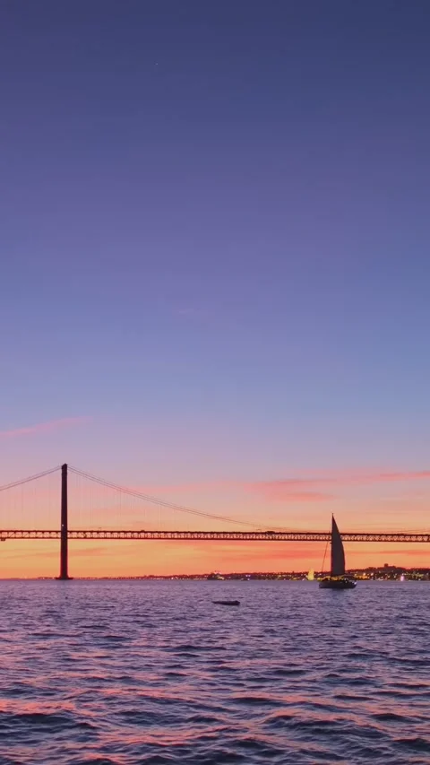 View of 25 de Abril Bridge over Tagus river on sunset. Lisbon, Portugal Video stock 330468445