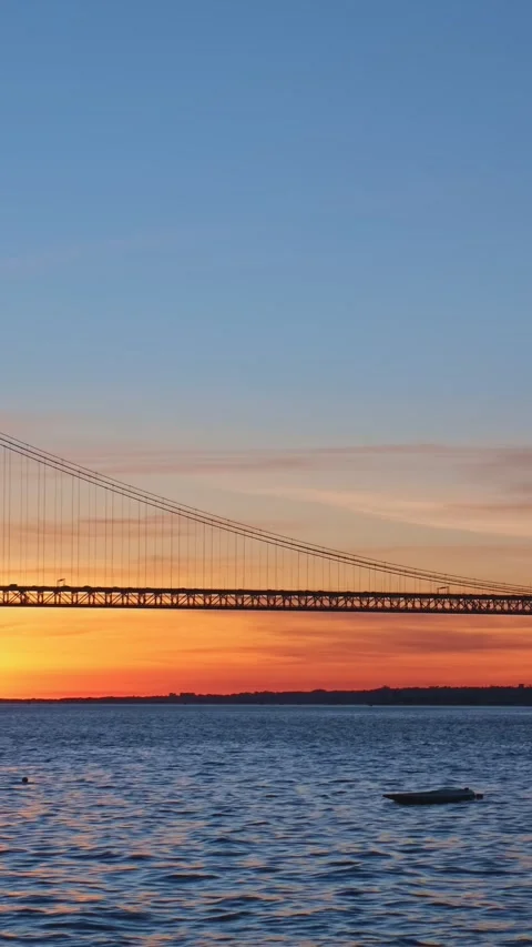 View of 25 de Abril Bridge over Tagus river on sunset. Lisbon, Portugal Stock Footage 342415010