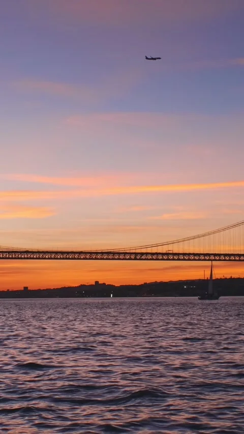 View of 25 de Abril Bridge over Tagus river on sunset. Lisbon, Portugal Stock Footage 342415024