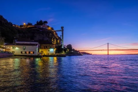 View of 25 de Abril Bridge over Tagus river on sunset. Lisbon, Portugal Stock Photos
