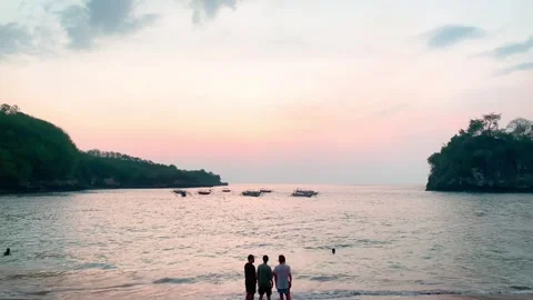 View of 4 people are talking and enjoying the sunset at crystal bay beach Stock Footage 295325198