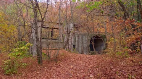 View of abandoned and closed and ruined entrance into tunnel of mine where Stock Footage 146547760