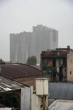 View of an abandoned building under construction behind an urban surrounding Stock Photos