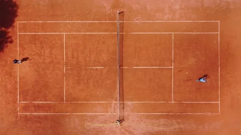 View from above, aerial view of two people playing tennis on a clay court Stock Footage 196148188