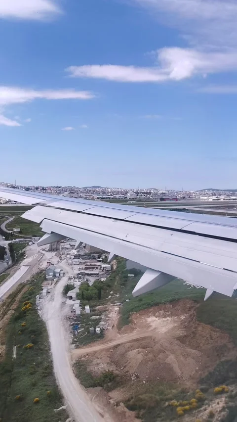 View from above: airplane wing over cityscape Stock Footage 314513922
