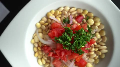 View from above and turning of a plate of chocho ceviche with chunks of tomato Vidéo 164556203