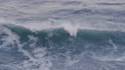 View from above of a big blue ocean wave curling and crashing down Stock Footage 147743957