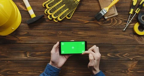 View from above on the black horizontal smartphone on the wooden desk of workman Stock Footage 96183217