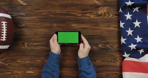 View from above on the black horizontal smartphone on the wooden table with Stock-Footage 96316625