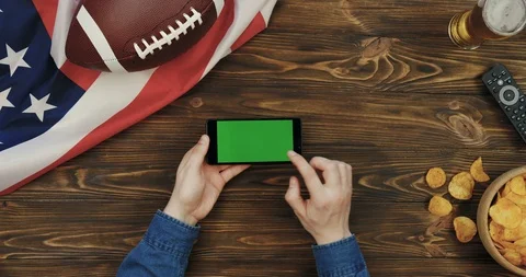 View from above on the black horizontal smartphone in hands of a man on the Stock Footage 96324149