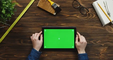 View from above on the black horizontal tablet device on the wooden desk with Video stock 96022667