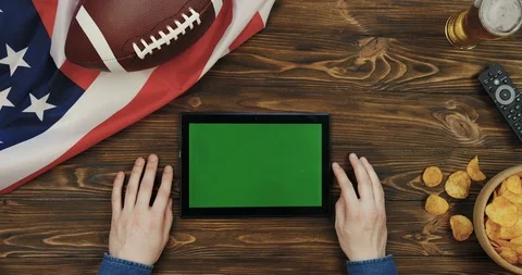 View from above on the black horizontal tablet device in hands of a man on the Stock-Footage 96323133