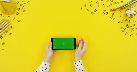 View from above on the black smartphone on the yellow table with birthday 스톡 동영상 89327853