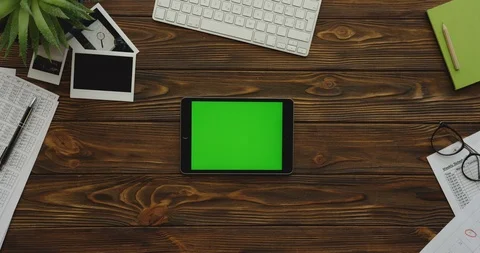 View from above on the black tablet computer with a green screen lying Stock-Footage 88415965