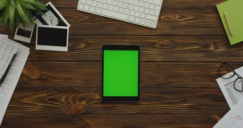 View from above on the black tablet computer with a green screen lying Stock Footage 88416366