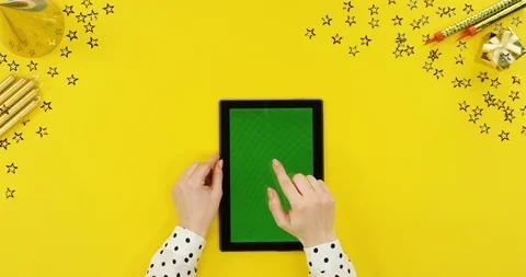 View from above on the black tablet device on the yellow table with birthday Stock Footage 89325019